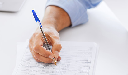 Image showing man filling tax form