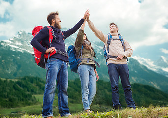 Image showing group of smiling friends with backpacks hiking