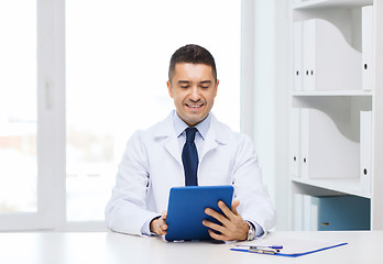 Image showing smiling male doctor in white coat with tablet pc