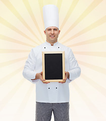 Image showing happy male chef cook holding blank menu board