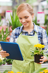 Image showing happy woman with tablet pc in greenhouse