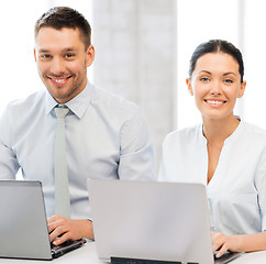 Image showing group of people working with laptops in office