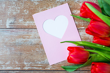 Image showing close up of tulips and greeting card with heart