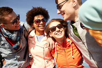 Image showing smiling friends in sunglasses laughing on street