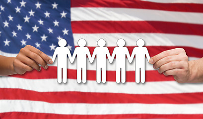 Image showing hands holding people pictogram over american flag