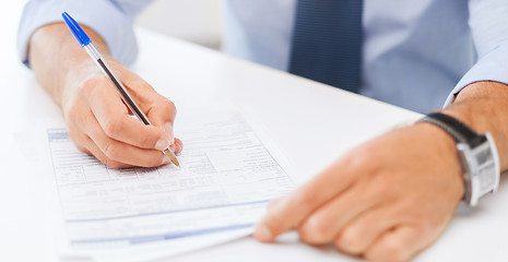 Image showing man filling tax form