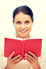 Image showing happy and smiling woman with book