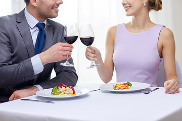 Image showing happy couple with glasses of wine at restaurant