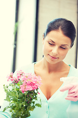 Image showing lovely housewife with flower