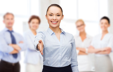 Image showing businesswoman with opened hand ready for handshake