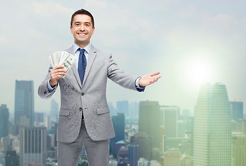 Image showing smiling businessman with american dollar money