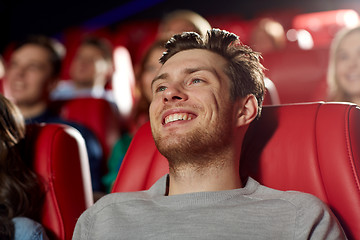 Image showing happy young man watching movie in theater