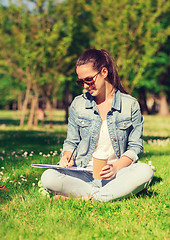 Image showing smiling young girl with notebook and coffee cup