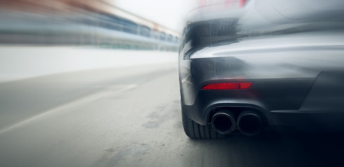 Image showing close up of car riding on highway from back