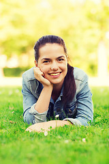 Image showing smiling young girl lying on grass