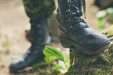 Image showing close up of soldier feet with army boots in forest