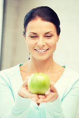 Image showing lovely housewife with green apple