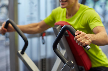 Image showing close up of smiling man exercising on gym machine