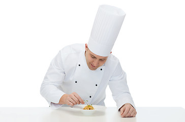 Image showing happy male chef cook decorating dish