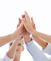 Image showing happy business team giving high five in office