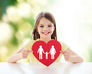 Image showing beautiful little girl sitting at table