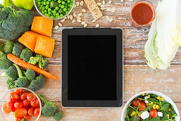 Image showing close up of blank tablet pc screen and vegetables