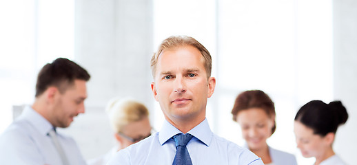 Image showing handsome businessman with team in office