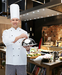 Image showing happy male chef cook holding cloche