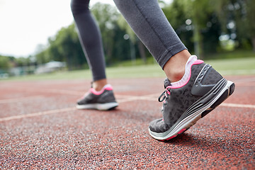 Image showing close up of woman feet running on track from back