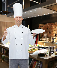 Image showing happy male chef cook showing thumbs up and plate