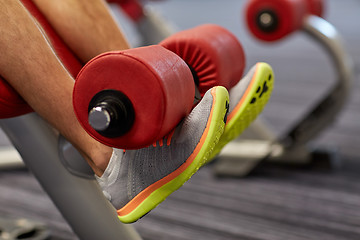 Image showing close up of man legs exercising on gym machine