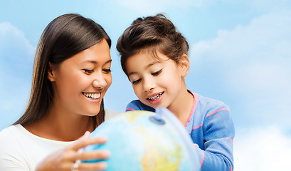Image showing happy mother and daughter with globe