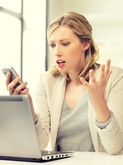 Image showing confused woman with cell phone