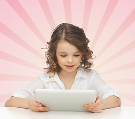 Image showing girl holding and looking to tablet pc computer