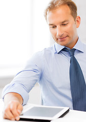 Image showing businessman with tablet pc and coffee in office