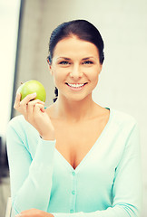 Image showing lovely housewife with green apple