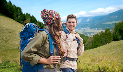 Image showing smiling couple with backpacks hiking