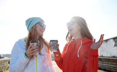 Image showing happy teenage girls with coffee cups on street