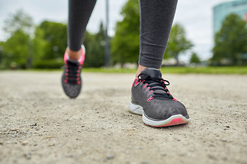 Image showing close up of woman feet running on track from back