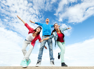 Image showing group of teenagers spreading hands