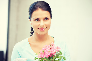 Image showing lovely housewife with flower