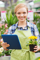 Image showing happy woman with tablet pc in greenhouse