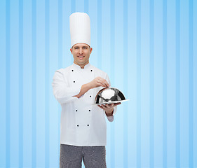 Image showing happy male chef cook holding cloche