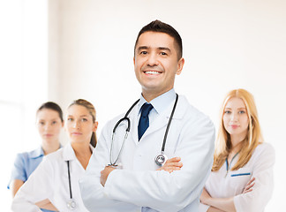 Image showing smiling male doctor in white coat at hospital