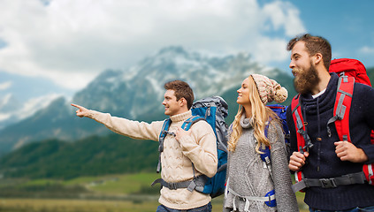 Image showing group of smiling friends with backpacks hiking