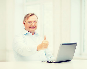 Image showing old man with laptop computer showing thumbs up