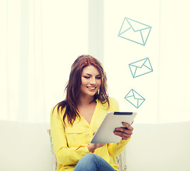 Image showing smiling woman with tablet pc computer at home