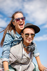 Image showing smiling teenagers in sunglasses having fun outside