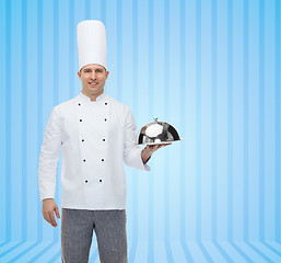 Image showing happy male chef cook holding cloche