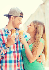 Image showing smiling couple with ice-cream in city